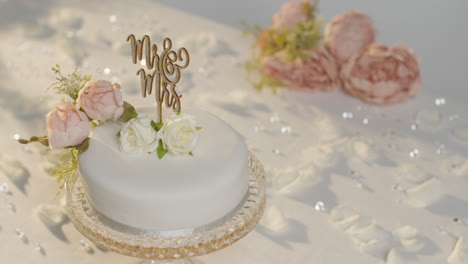 Close-Up-Of-Wedding-Cake-On-Decorated-Table-At-Wedding-Reception-1